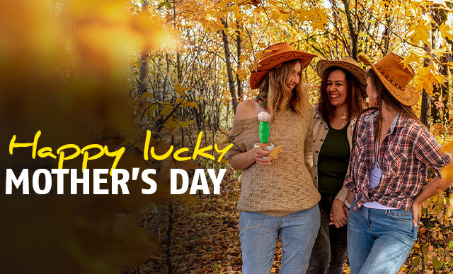 three happy women with cowboy hats one holding a blooming cactus