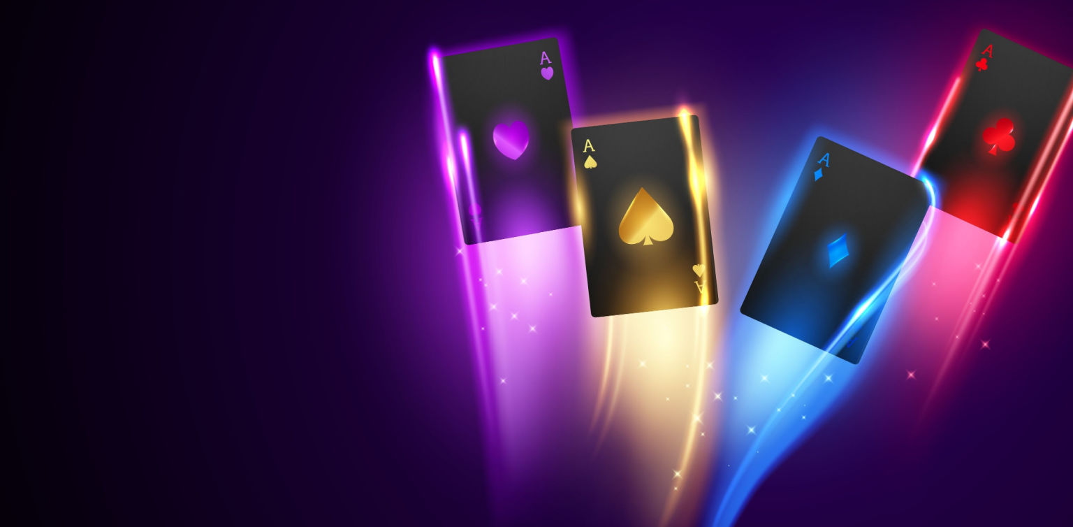 Four black playing cards, with multi-color trimmings, on a dark purple background