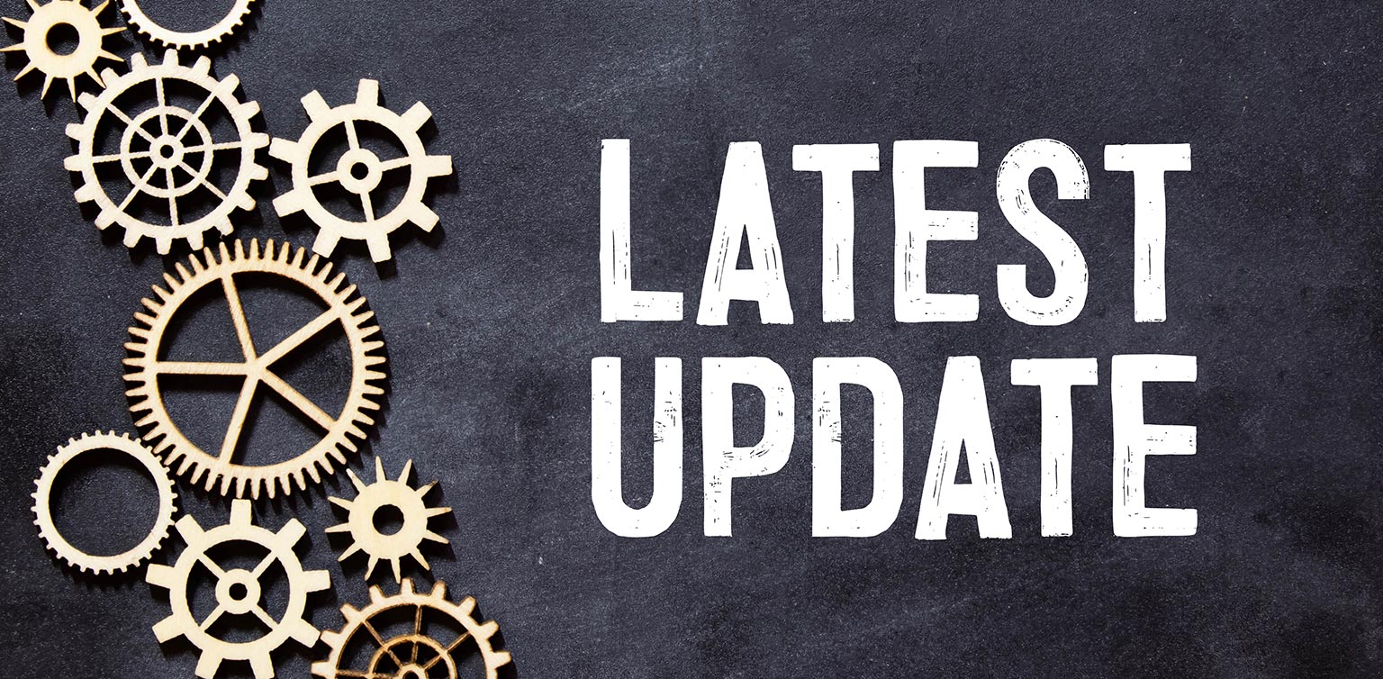 An image of a blackboard with “latest update” written in white chalk, and mechanical gears in different sizes