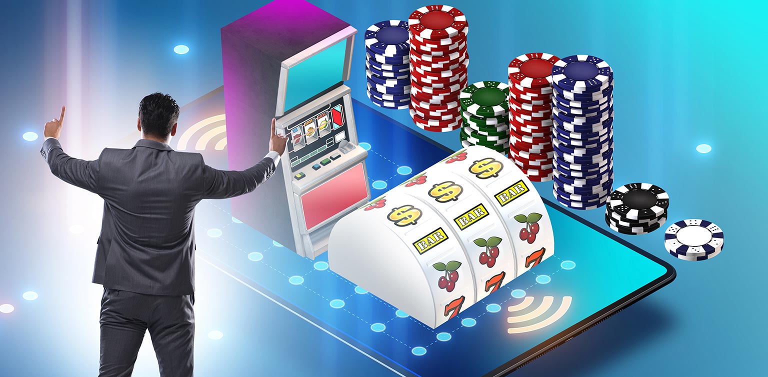 An image of a man standing with arms raised in front of huge smartphone featuring 3 reels, a slot machine and casino chips