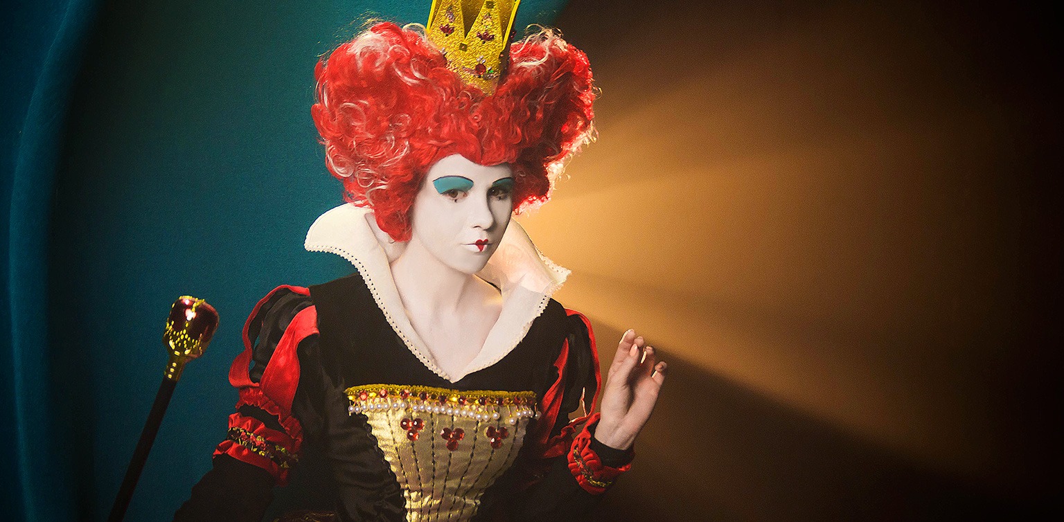 A photograph of the Queen of Hearts on an abstract blue, orange and black background